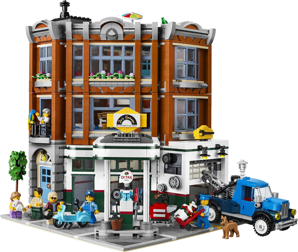 LEGO model of a city street with buildings, vehicles, and people on a white background