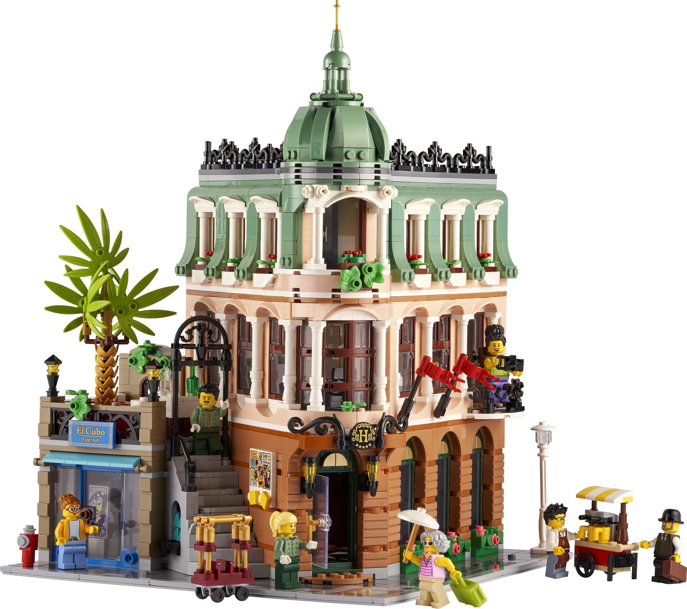 Detailed LEGO model of a building with people and palm tree on a white background