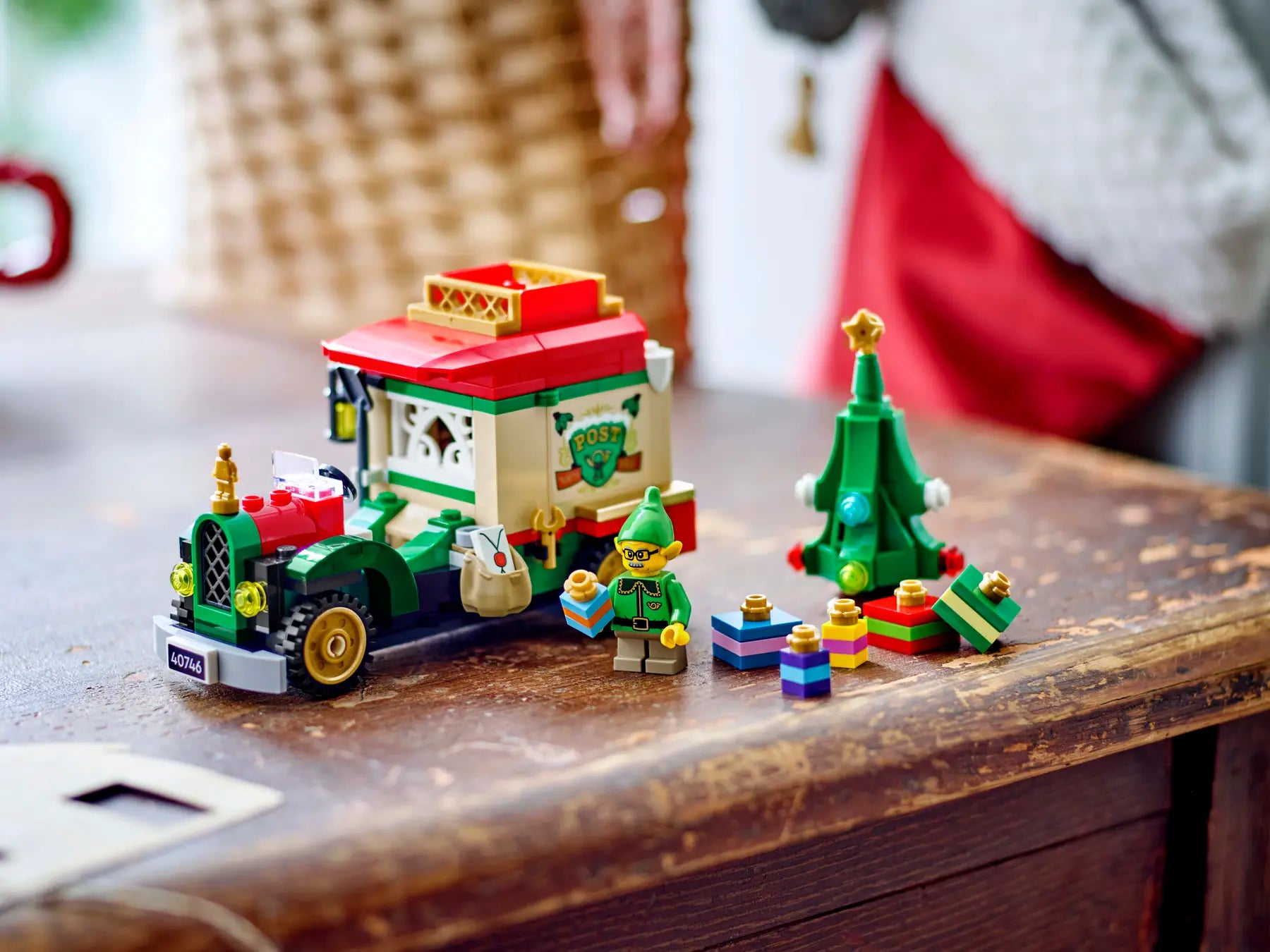 Toy set with a Christmas-themed train and trees on a wooden surface
